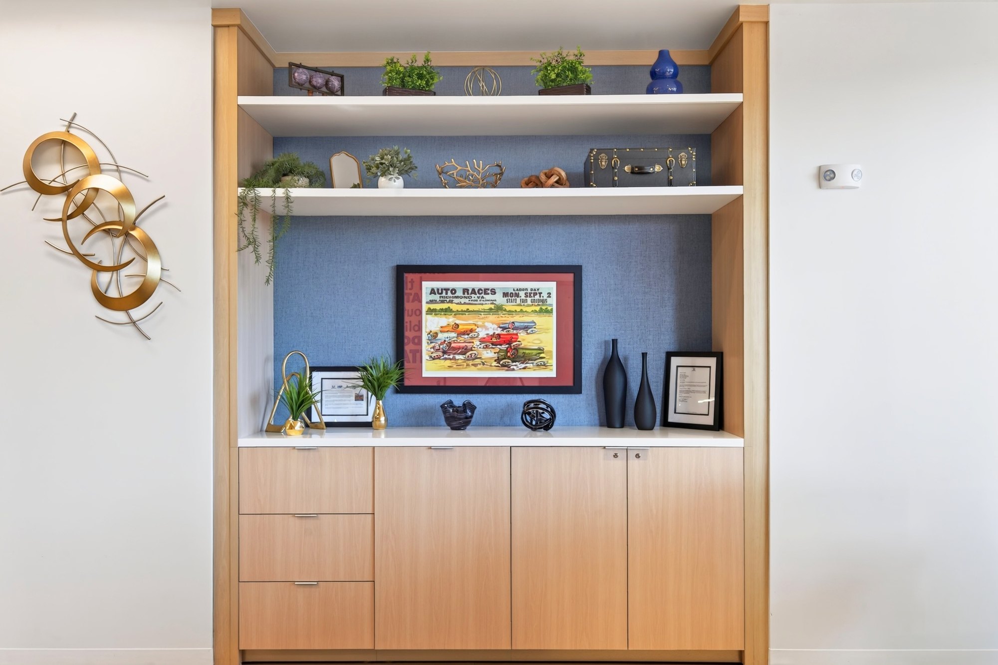 Shelving bay with framed art and cabinetry, Honda dealership showroom, Short Pump, Virginia