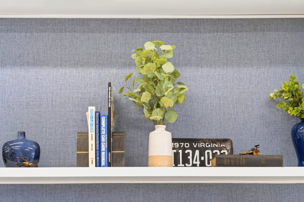 Shelf vignette with plant, books and a licence plate, Honda dealership showroom, Short Pump, Virginia