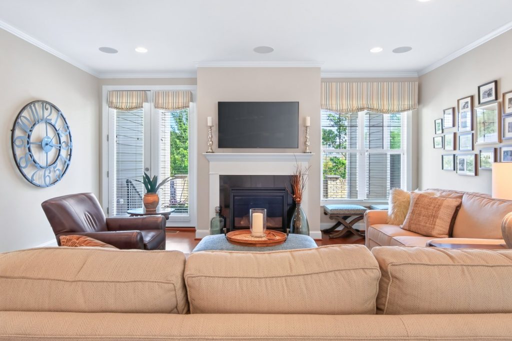 Family room with Roman shades flanking the fireplace
