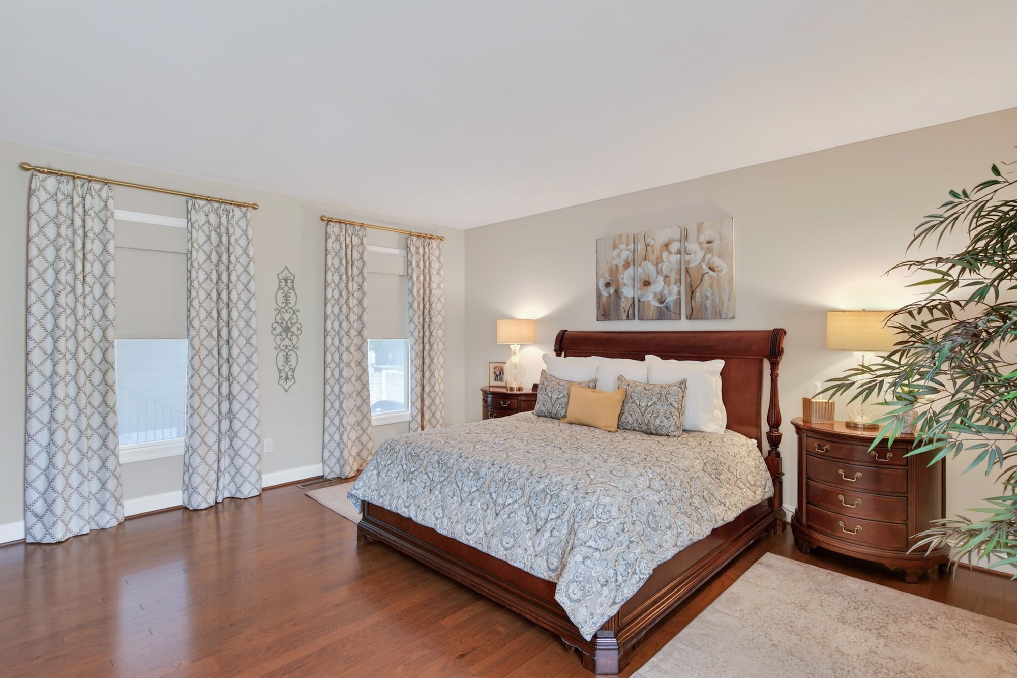 Primary suite with dual roller shades and stationary side panels