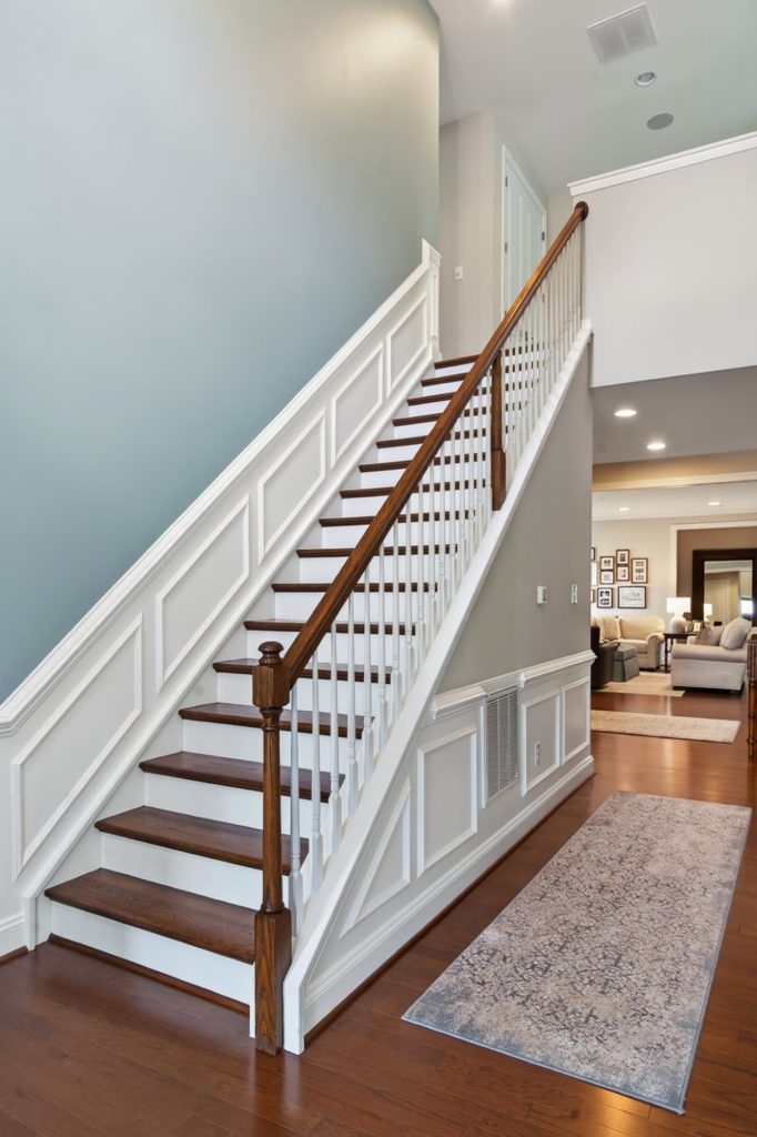 Stair hall with white balustrade and wainscoting