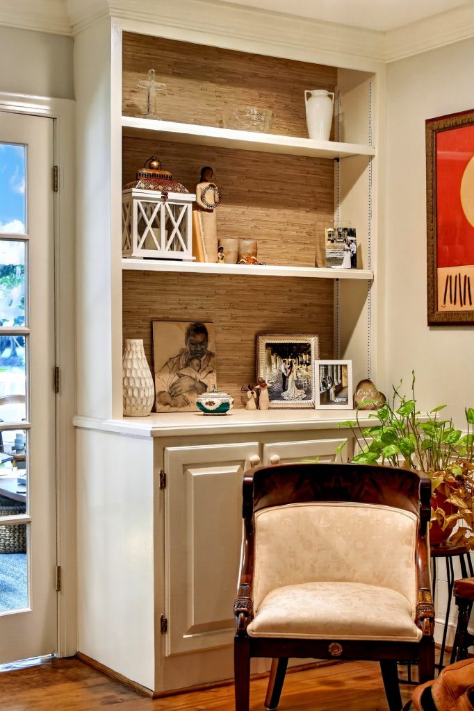 Built-in shelving beside a window, styled with books and ceramics