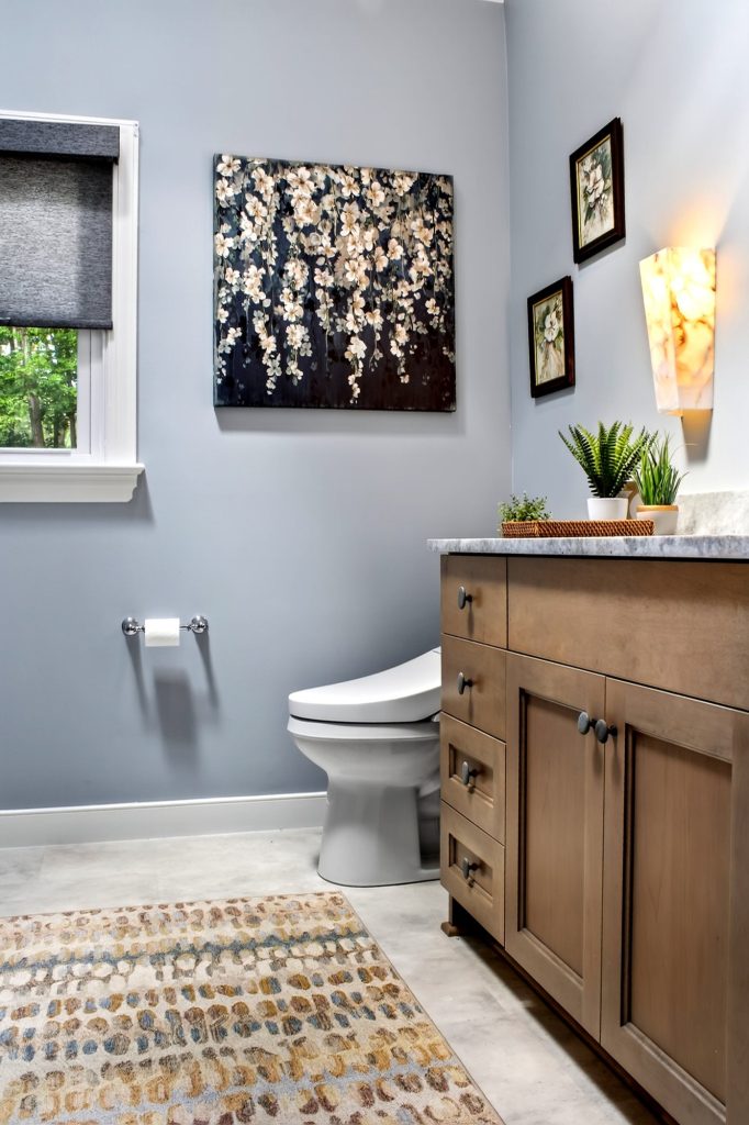 Powder room with a wood vanity and framed artwork above